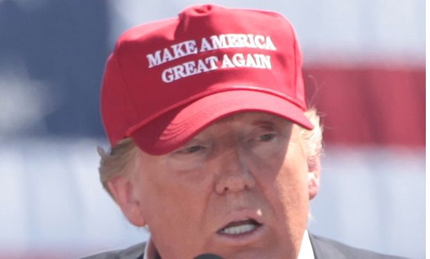 Trump in his signature make america great again hat