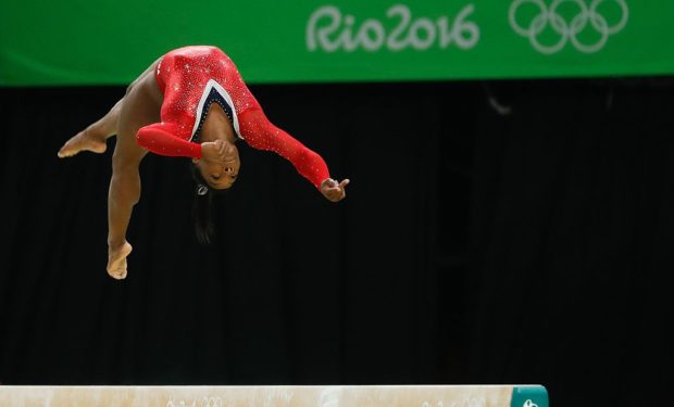 Simone_Biles in the air at the Olympics, barefoot