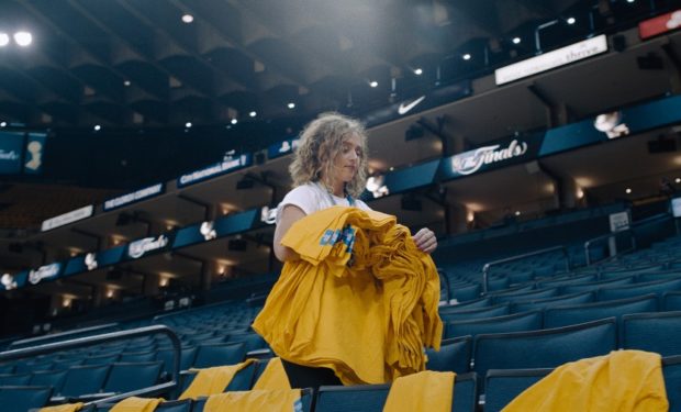 Golden State Warriors Megan Cooper putting shirts out