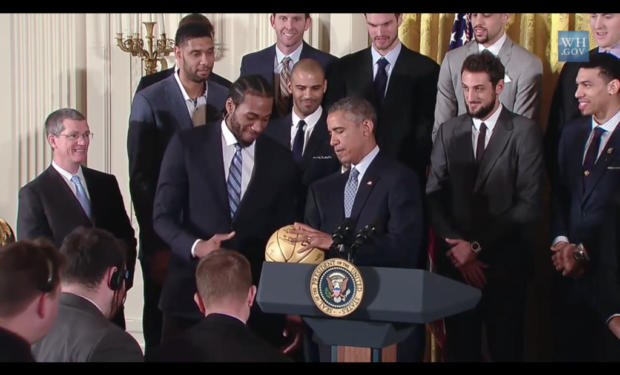 Kawhi_Leonard_presents_ball_to_President_Obama_3_2015-01-12