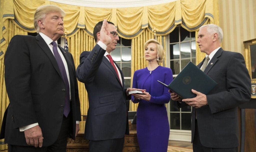 Mnuchin being sworn in at White House, photo: <a href="https://commons.wikimedia.org/wiki/File:Steve_Mnuchin_swearing_in.jpg">Vice President Pence @ twitter</a>, Public domain, via Wikimedia Commons